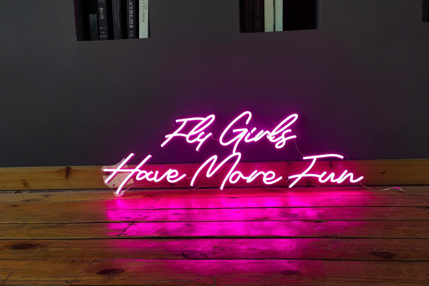'Fly girls have more fun' neon sign