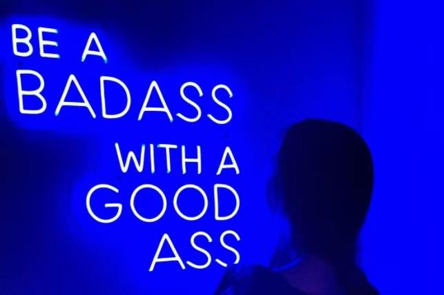 'Be a badass with a good ass' neon sign