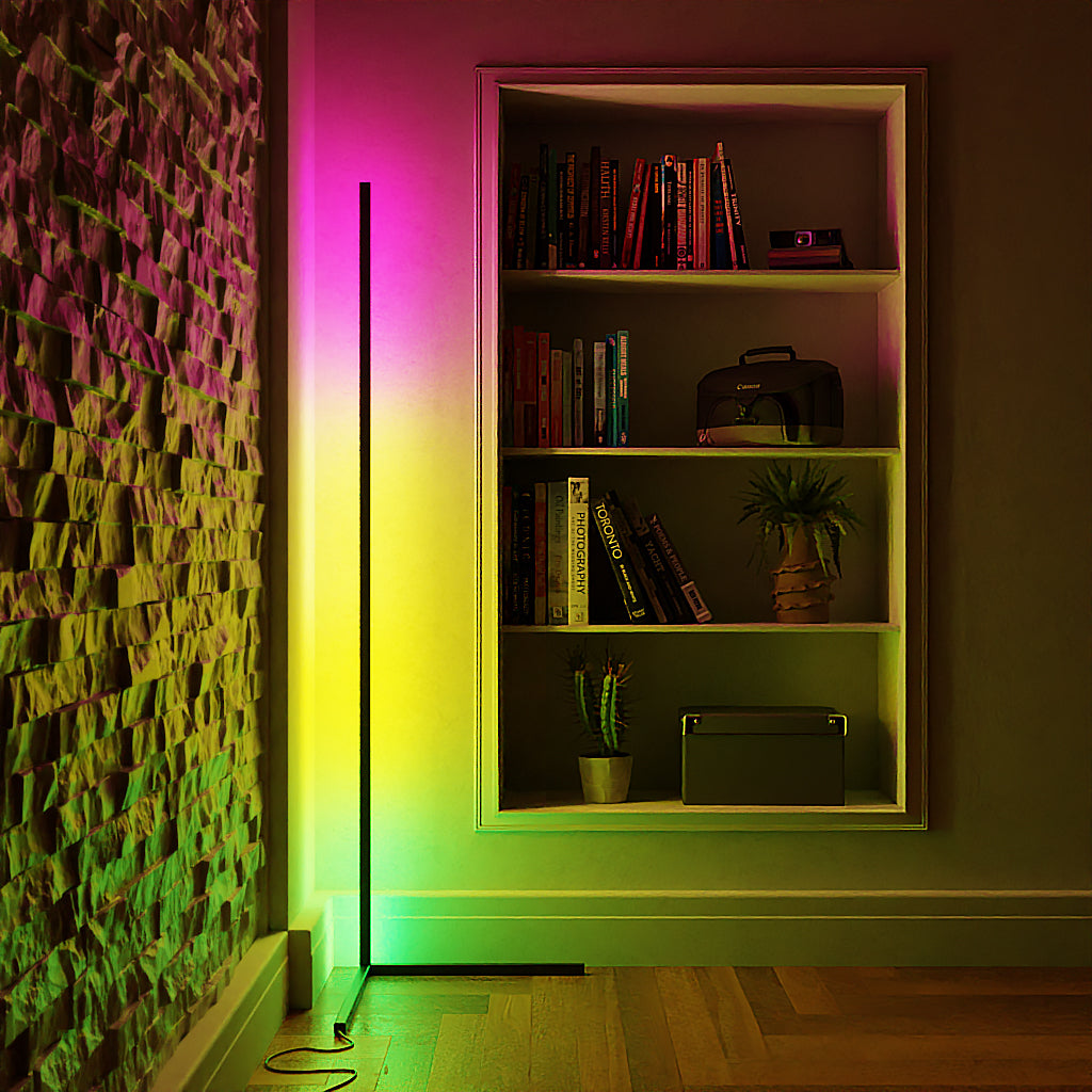 LED corner lamp glowing pink and green beside a bookshelf